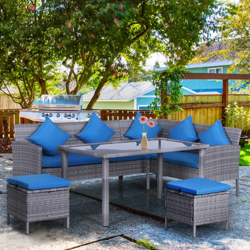 Grey rattan garden dining set with bright blue cushions under shady backyard trees.