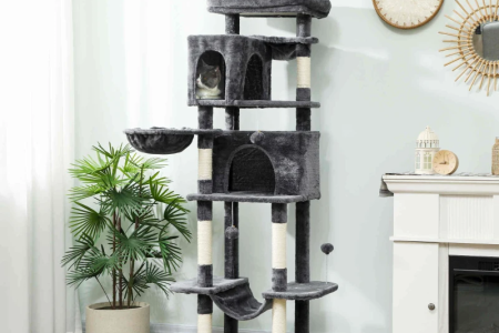 Grey multi-level cat tree beside a fireplace and plant.