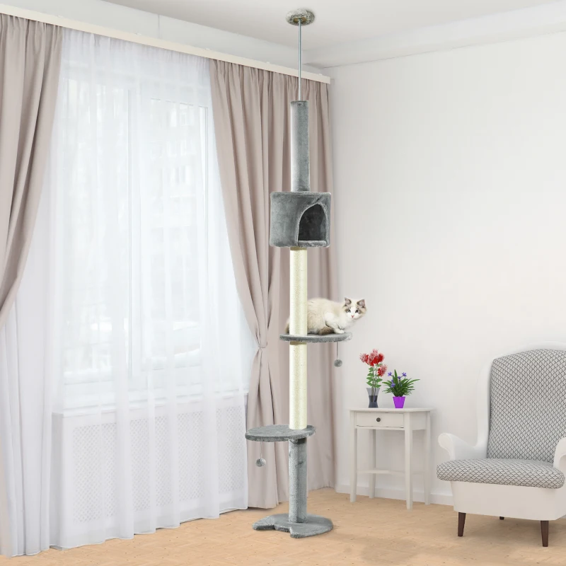 Tall grey cat tower reaching ceiling with platforms and condo.
