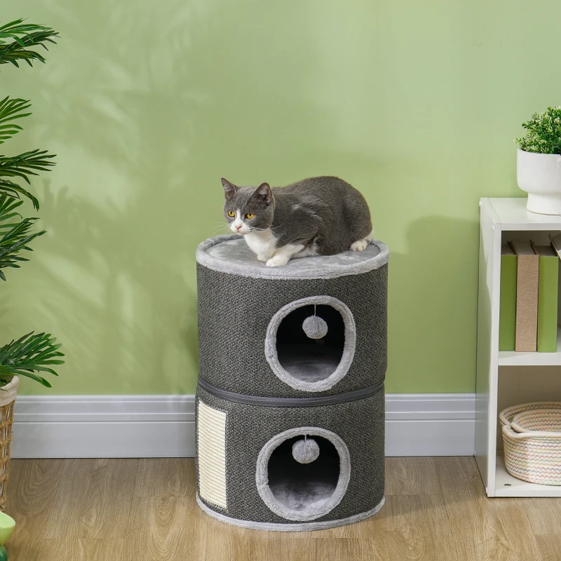 Cat resting on two-storey round cat condo with grey fabric.