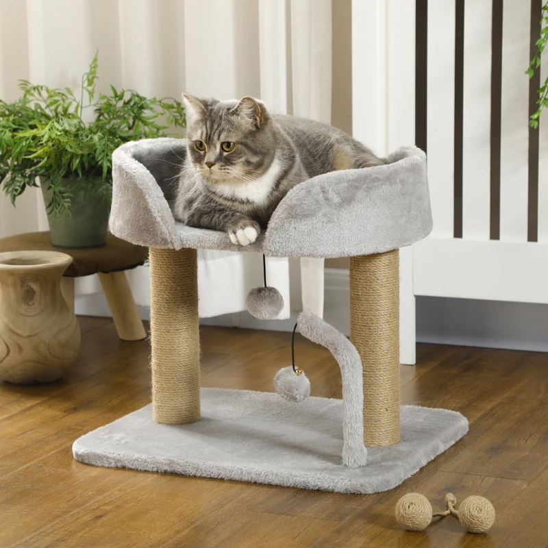 Cat resting on small grey cat tower with rope scratching posts.