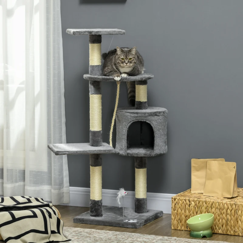 Grey cat sitting on compact scratching tower with rope toys.