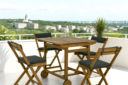 Outsunny wooden 5-piece patio dining set with wheeled table and black cushioned chairs.