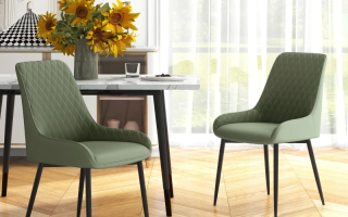Two green upholstered dining chairs with black legs beside a modern dining table.