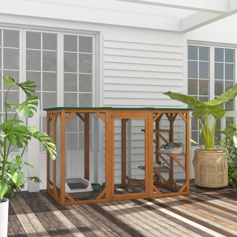 Modern outdoor wooden catio with sloped roof, hammock, and cats playing inside.