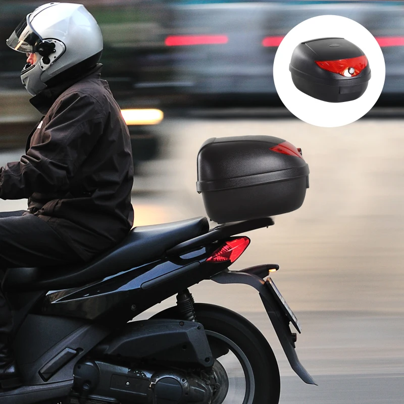 Rider on black scooter equipped with lockable rear motorcycle storage trunk.