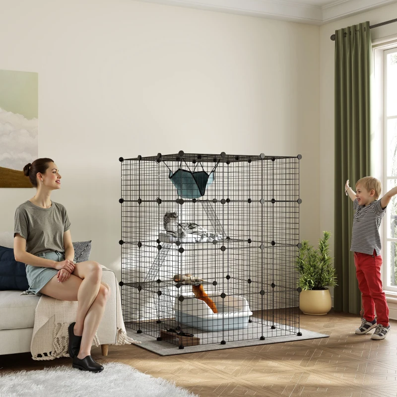 Indoor modular cat cage with hammock, woman watching, child playing nearby.