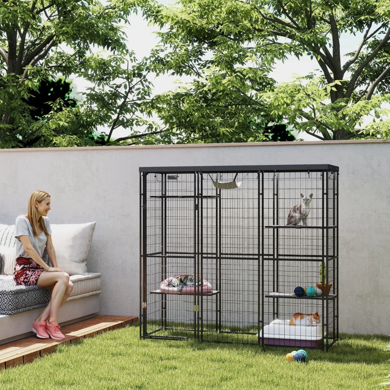 IndoorOutdoor Cat Enclosure with Hammock.webp – Black metal outdoor cat enclosure with hammock and cats resting on platforms.