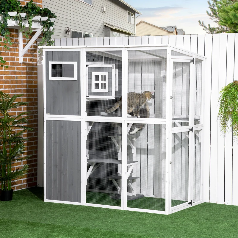 Tall white and grey walk-in catio with multiple levels and cats climbing inside.