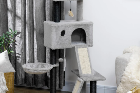 Grey multi-level cat tree with hammock, condo, ramp, and top perch in a modern living room.
