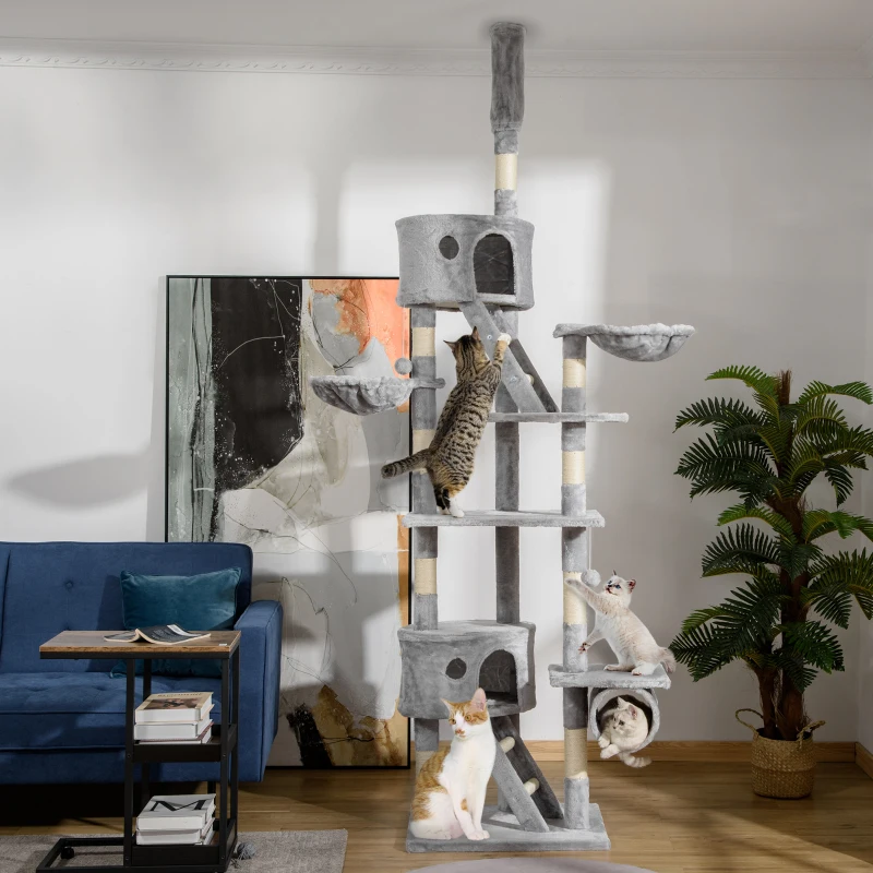 Extra-tall grey cat tower with multiple platforms, condos, and several cats climbing and resting.