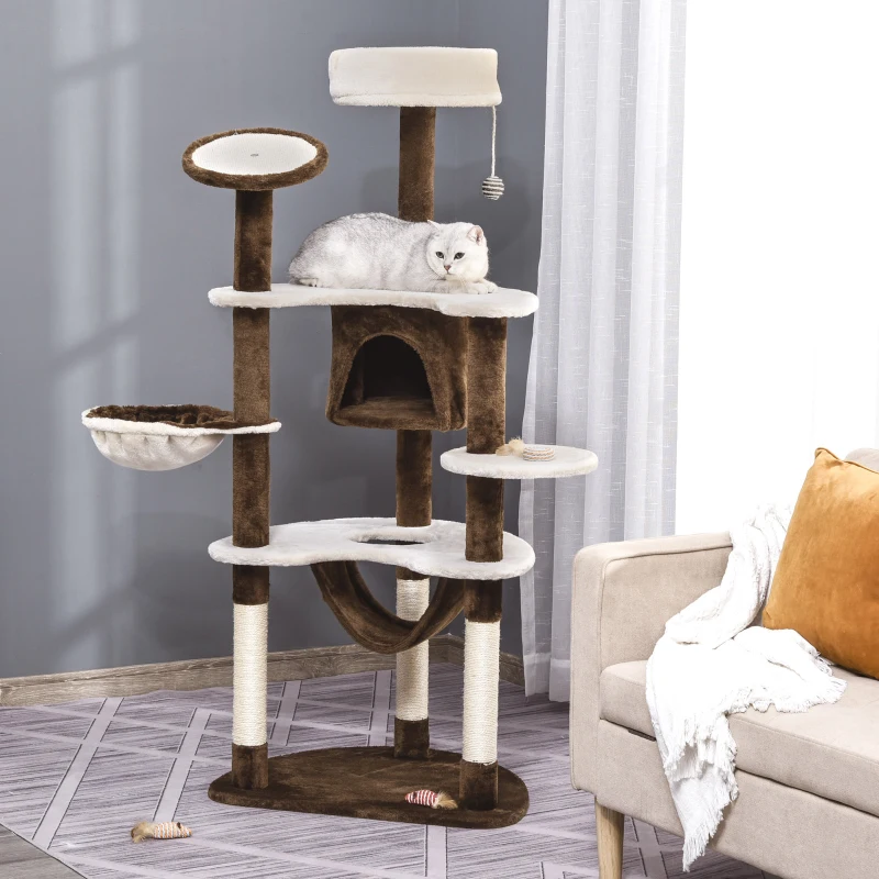Brown and white plush cat tree with hammock, condo, perches, and a cat lying on the top platform.