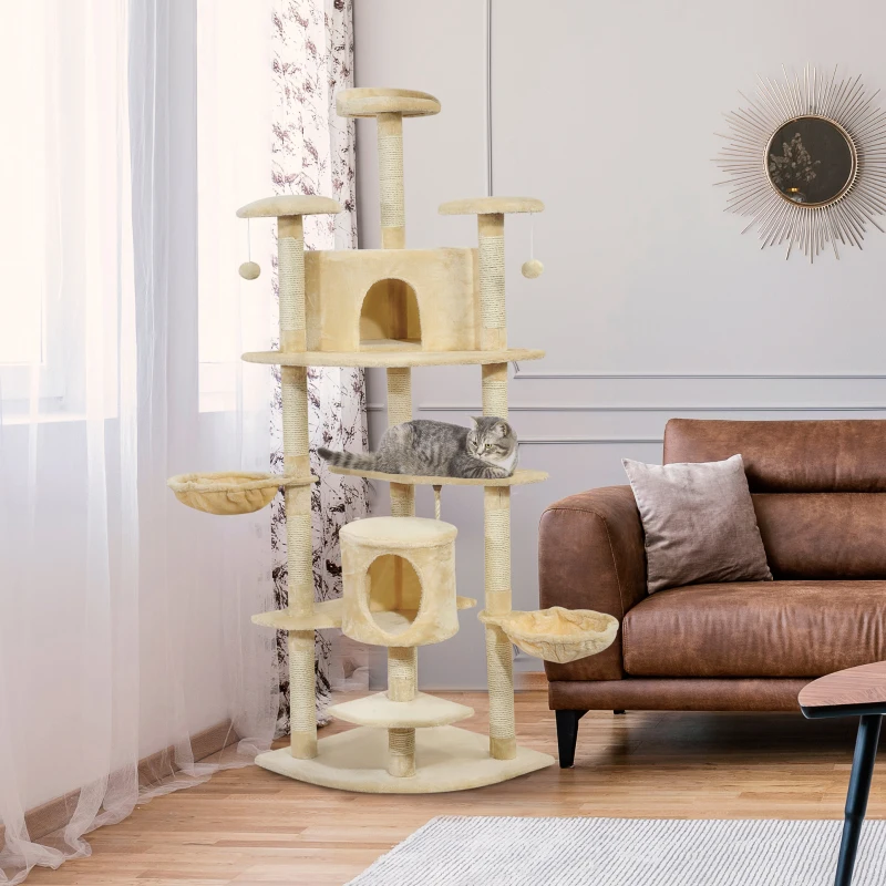 Cream multi-level cat tower with tall perches, condos, baskets, and a cat lounging on top.