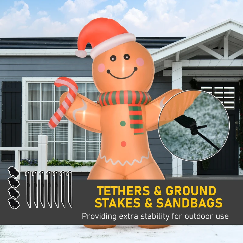 Gingerbread man inflatable with ground stakes, tethers, and sandbags for outdoor stability.