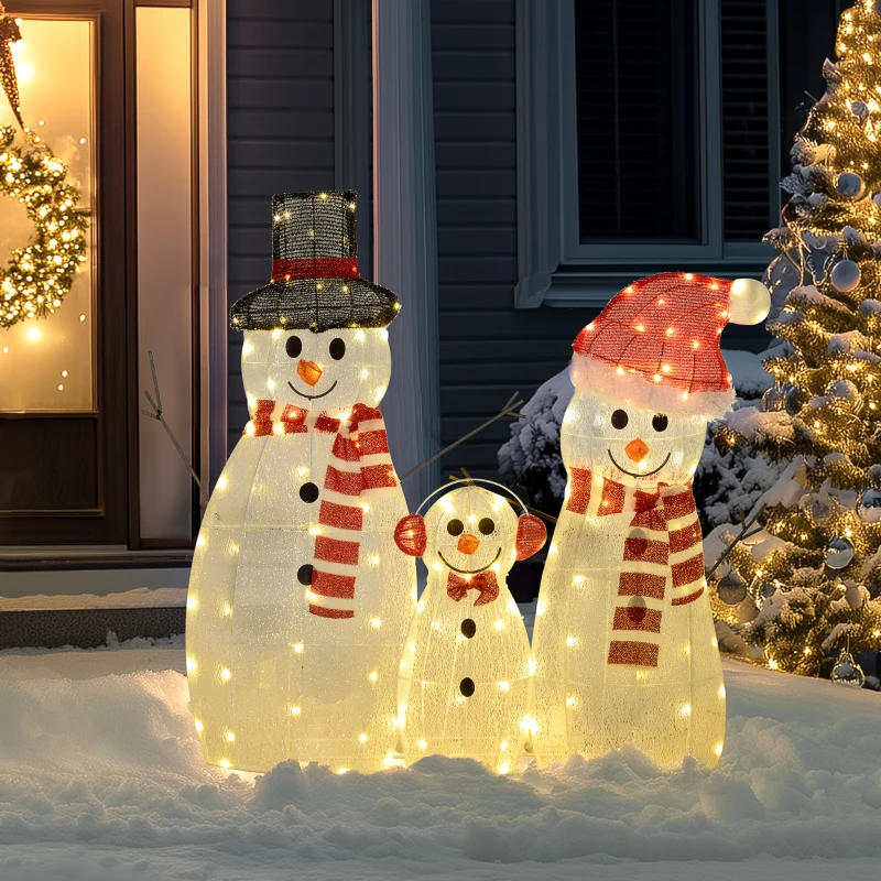 snowman family glowing in snowy yard