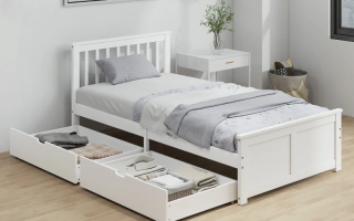 White twin daybed with under-bed drawers in bright modern bedroom.