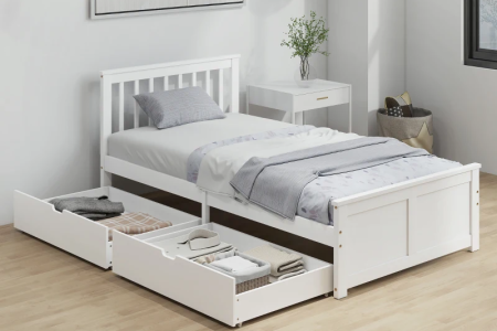 White twin daybed with under-bed drawers in bright modern bedroom.