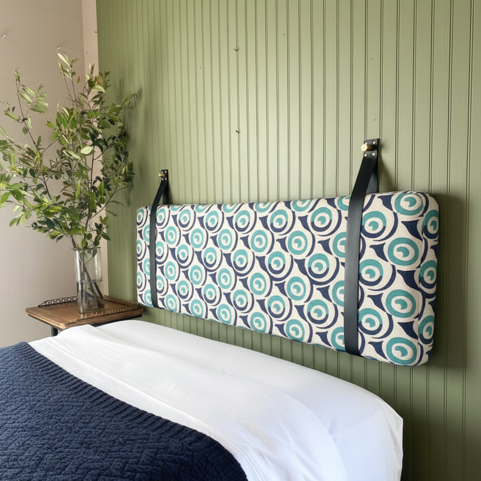 Soft padded headboard with grey fabric cushions creating a cosy, modern look.