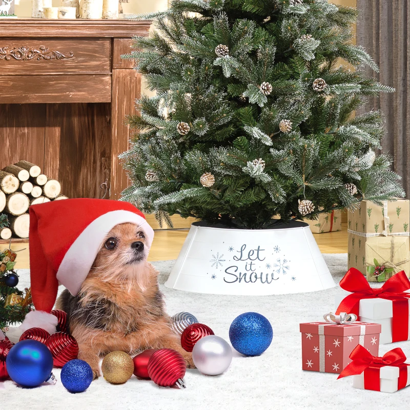 Dog wearing Santa hat beside Christmas tree with white “Let It Snow” collar and festive ornaments.