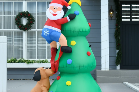 Inflatable Santa climbing Christmas tree with dog pulling pants.