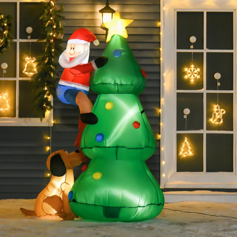 Inflatable Santa climbing Christmas tree beside lit window décor.