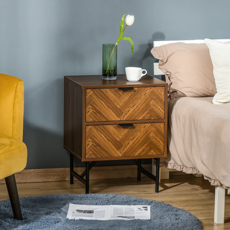 Woodgrain nightstand with chevron design and black legs beside bed.