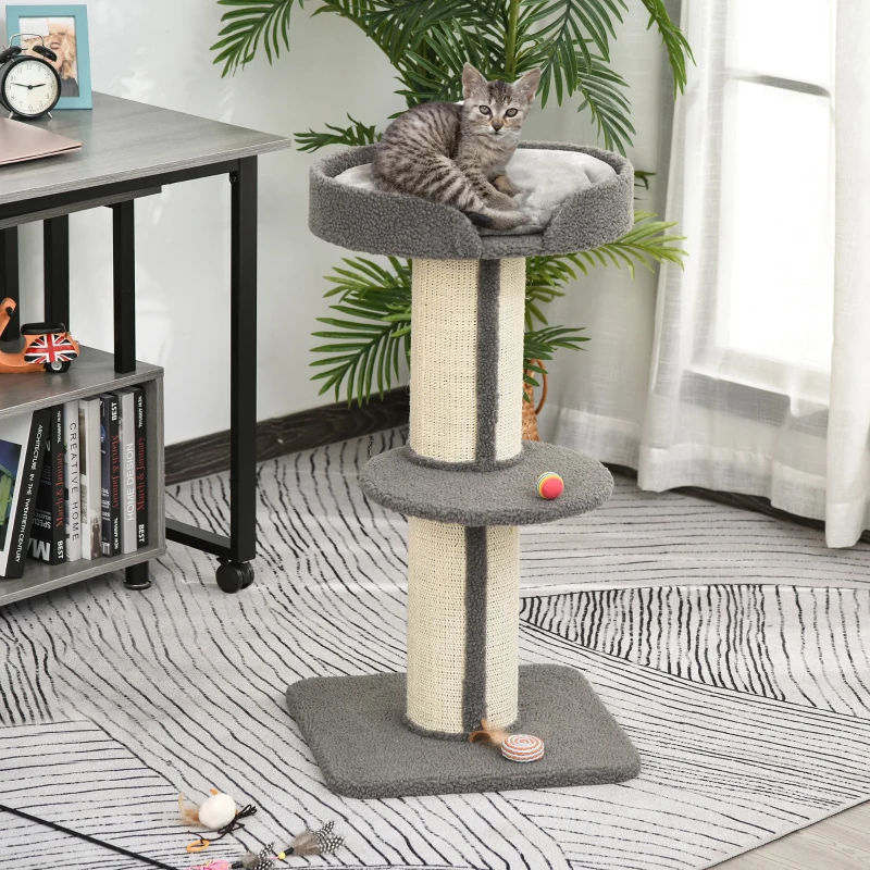 Kitten sitting on tall cat tree with sisal scratching posts and toys