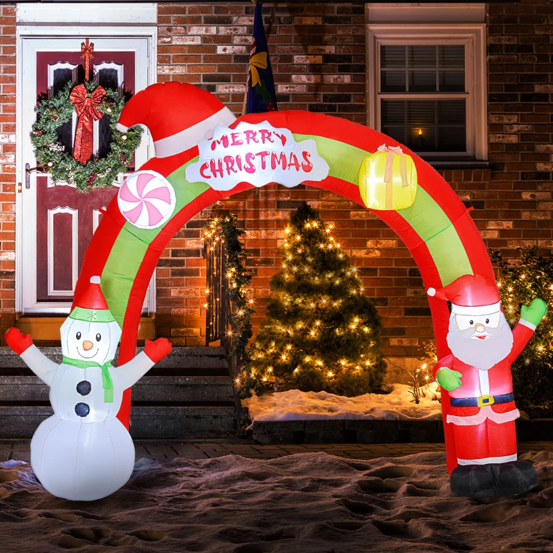 Santa and snowman inflatable arch glowing outside a decorated home
