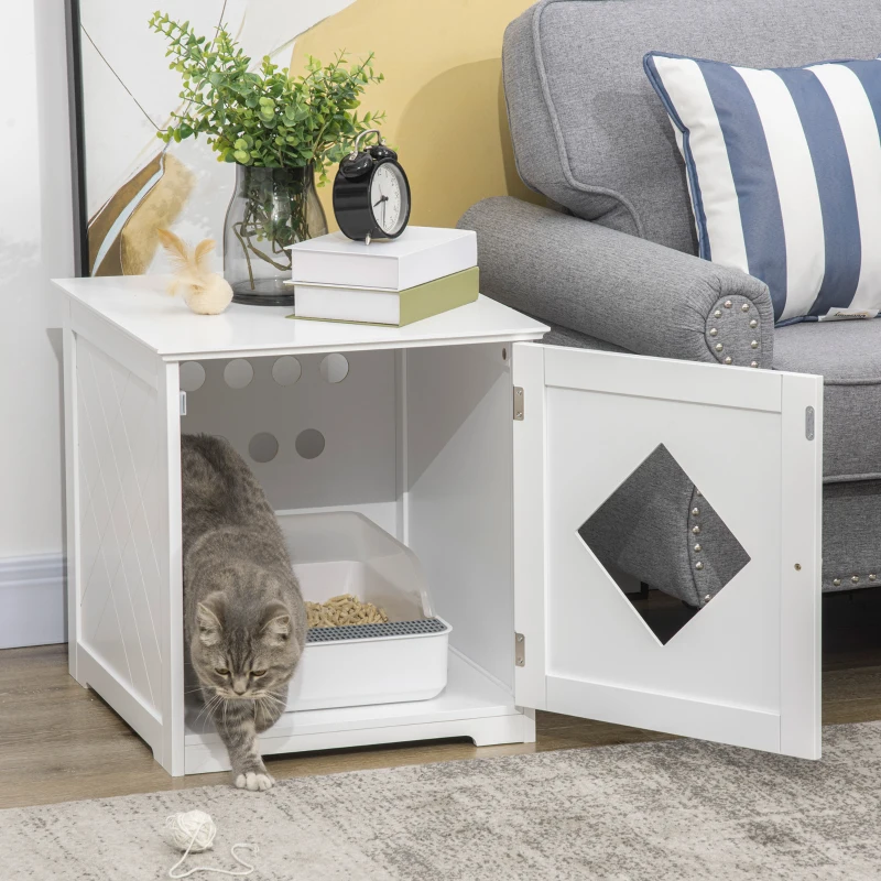 Grey cat stepping out of white furniture-style litter cabinet.