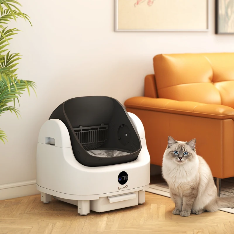 White smart litter box placed beside sofa with cat.