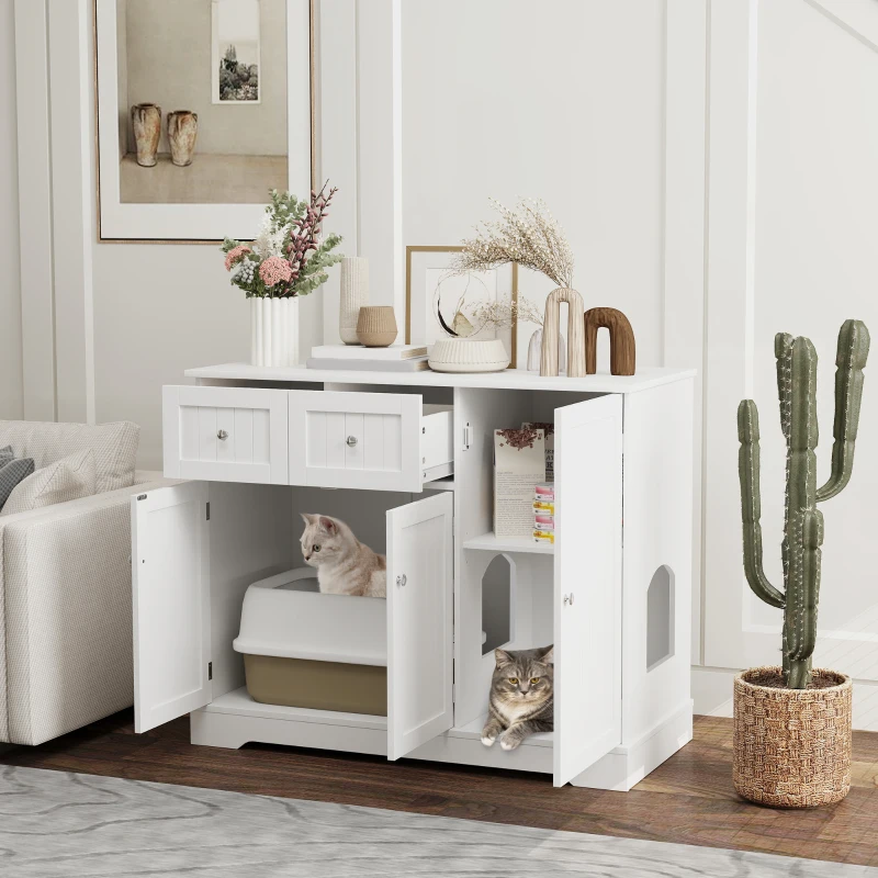 Two cats inside a white furniture cabinet with open doors.