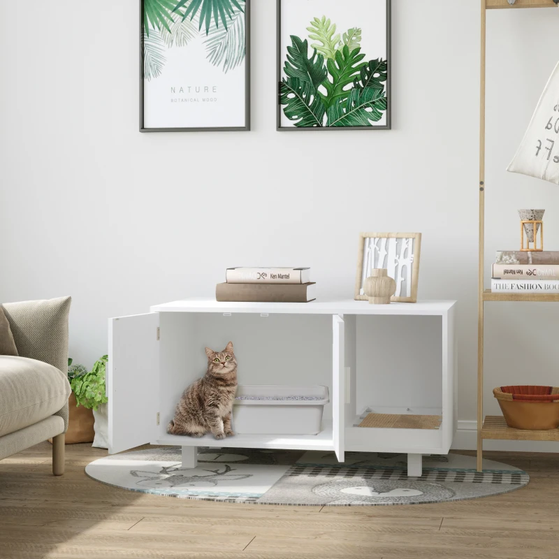 Cat sitting inside a white cabinet litter enclosure in living room.