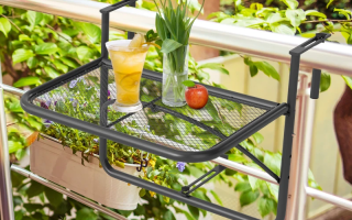 Balcony hanging table holding drinks and flowers.