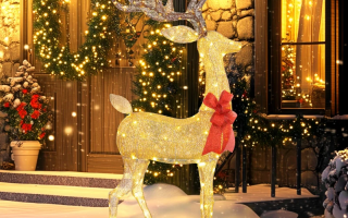 Glowing outdoor Christmas deer with golden lights and red bow in snowy festive garden