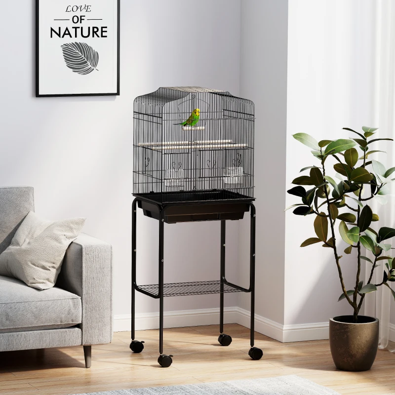 Black bird cage with green bird on rolling stand.