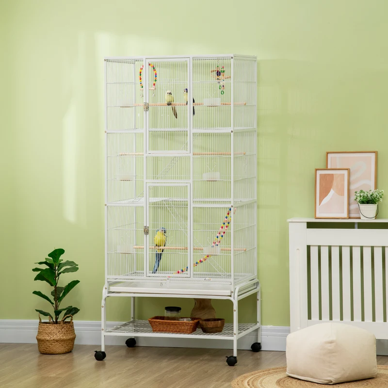 Large white activity bird cage with multiple birds indoors.
