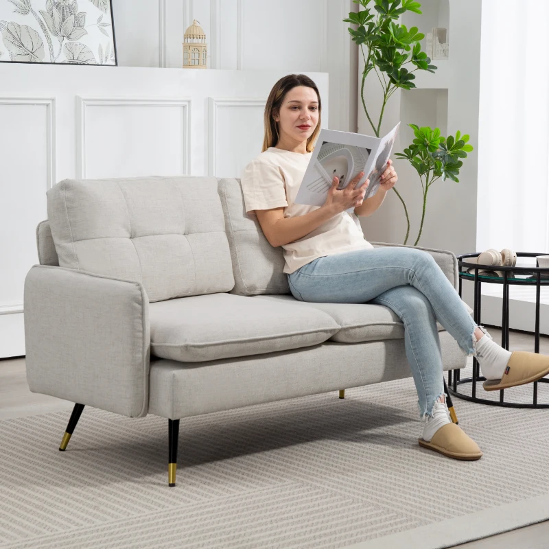 Light beige linen loveseat with tufted back cushions and sleek arms in a modern home setting