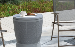 Outdoor patio cooler side table in grey used as a small table beside chairs.