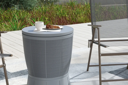 Outdoor patio cooler side table in grey used as a small table beside chairs.