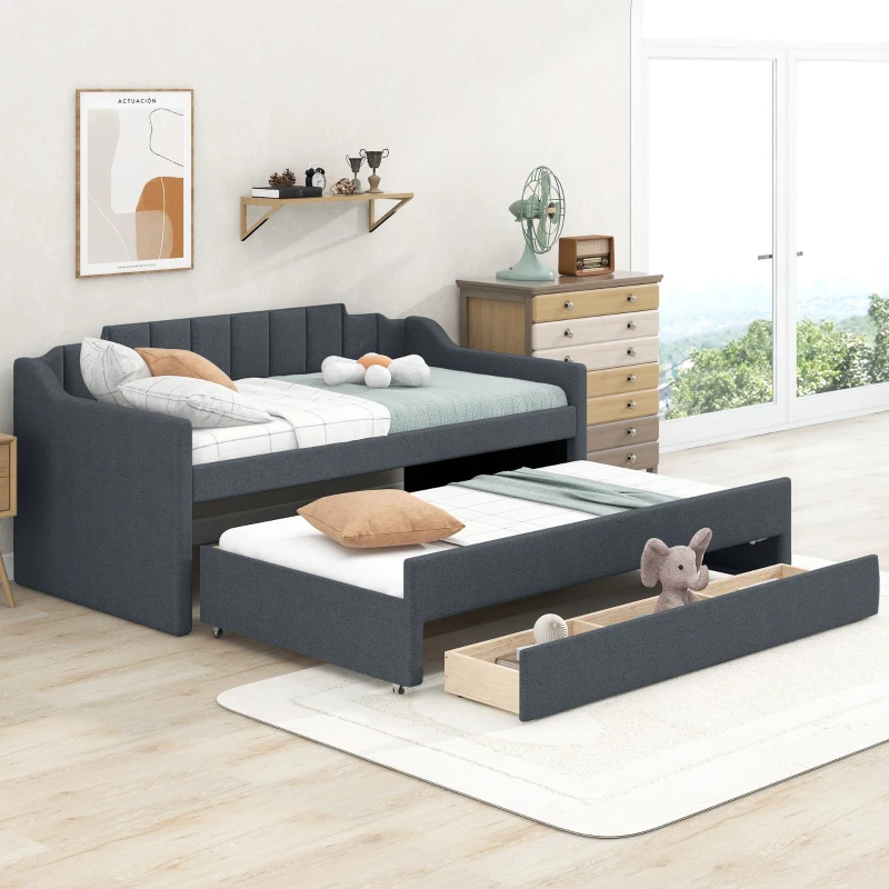 Grey upholstered daybed with pull-out trundle and storage drawer in bright modern bedroom.