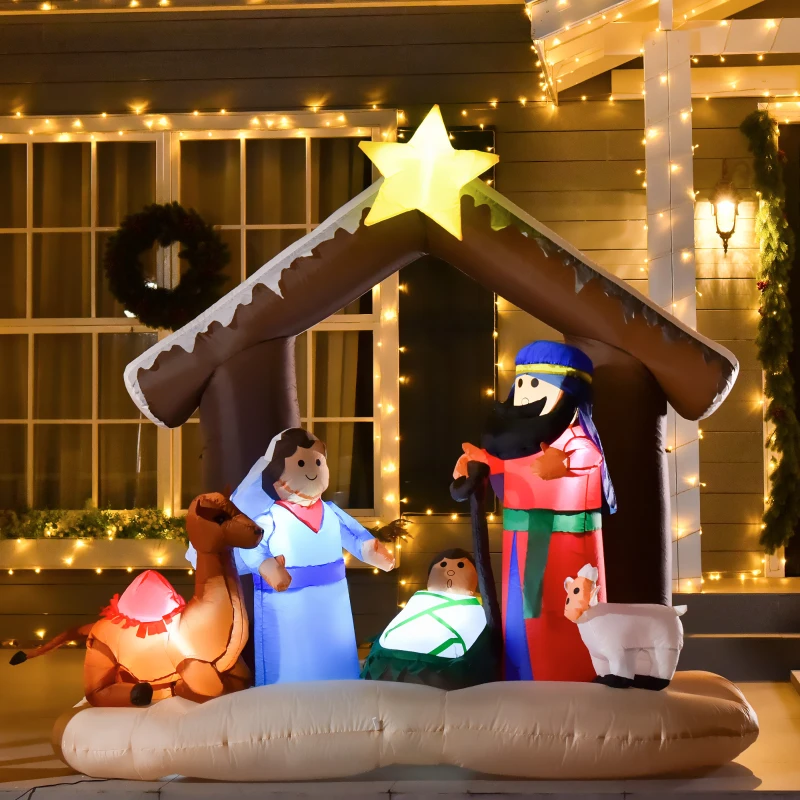 Lighted nativity inflatable with figures under star-topped stable in front-yard Christmas décor.