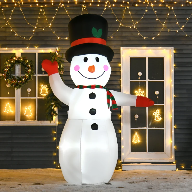 Large snowman inflatable with top hat and scarf waving beside window with lighted décor.