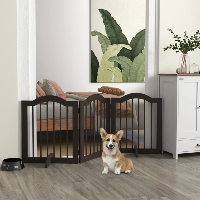 Corgi sitting by dark-brown freestanding dog gate in modern home hallway.