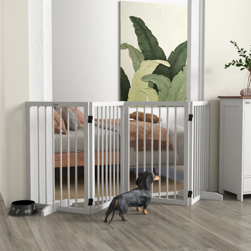 White freestanding foldable 4-panel pet gate with small dachshund near bedroom doorway.