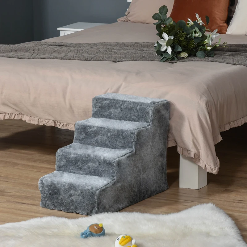 Grey carpeted dog stairs placed beside a bed in a bedroom.