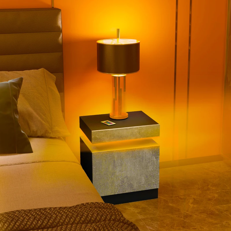 Modern grey nightstand with LED lighting and table lamp in warm glow.