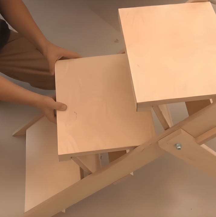 Wooden dog stairs being assembled with hands holding a step.
