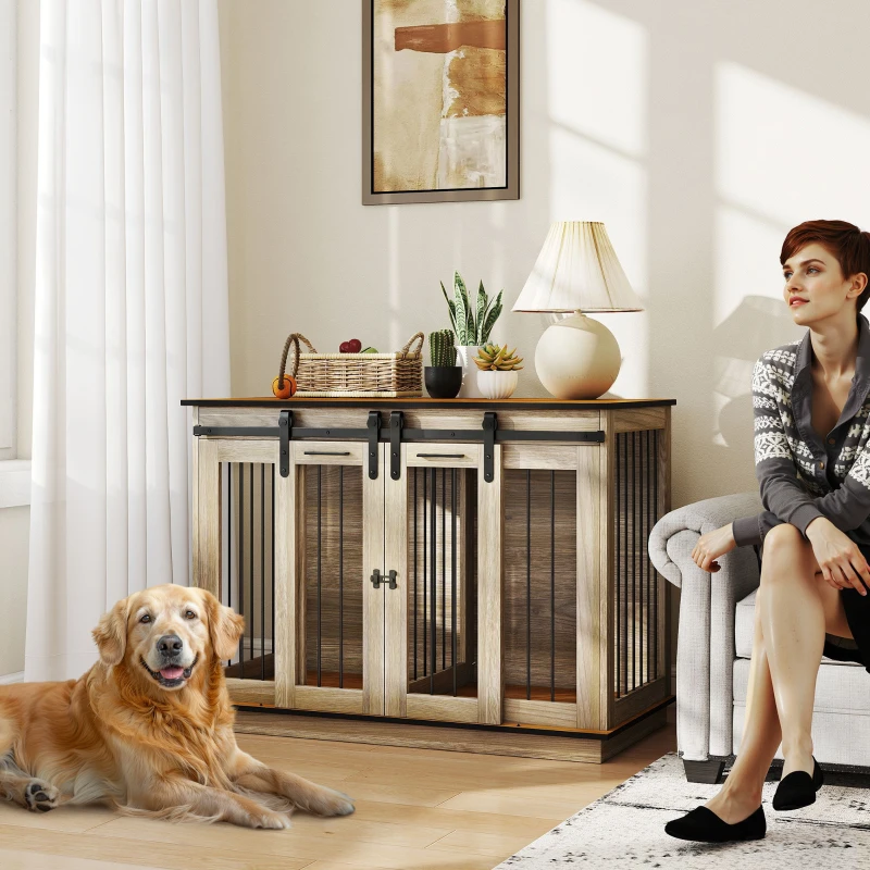 Large double dog crate beside woman and golden retriever in bright living room.