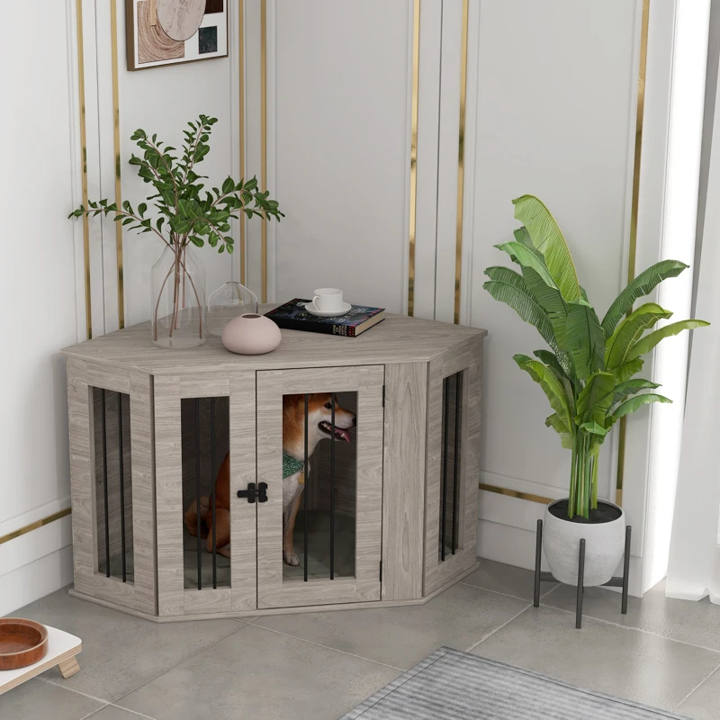 Gray corner dog crate table with dog and houseplant beside.
