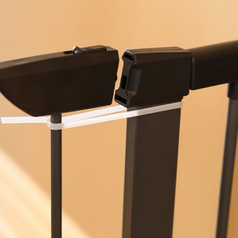 Close-up of mounting cup alignment on a metal pet gate for added wall stability.